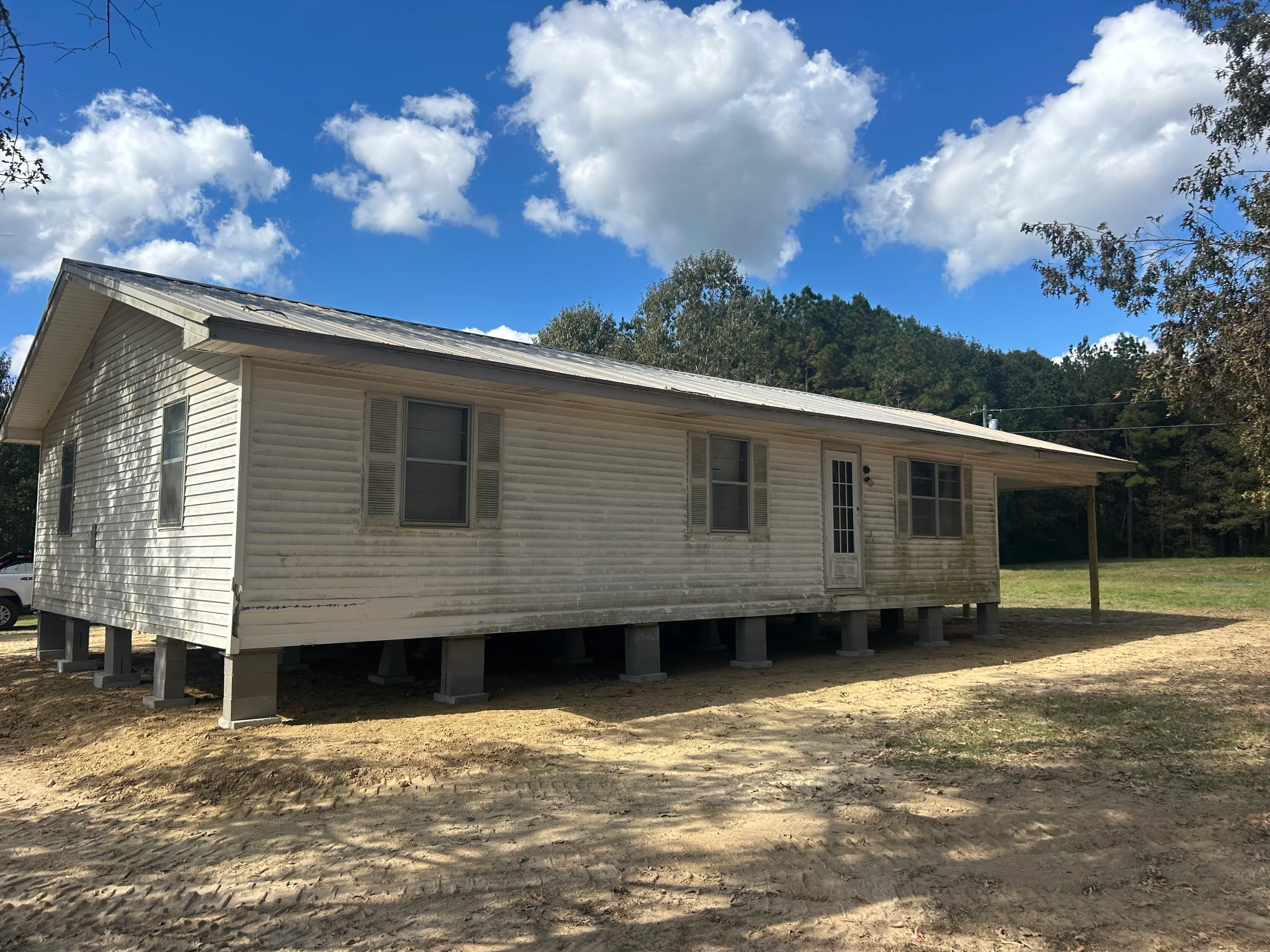 Elevated mobile home on concrete support piers with new foundation system installed